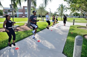 Bootcamp participants do cardio exercise under the guidance of instructor Kamal Cudjoe. Photo by Ryan Murphy.