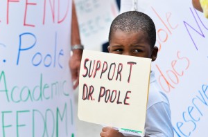 Kristopher Thurston, 4, holds a sign in front of other posters brought to show support for instructor Deandre Poole Tuesday, April 9, Thurston came to the protest with his mother and friend of Poole, Kamae Haltaufderhyde. Photo by Ryan Murphy.