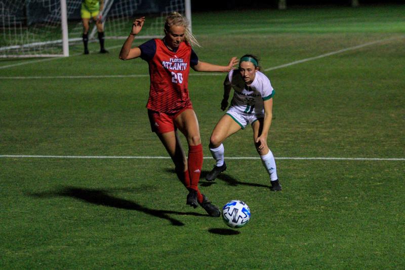 Thelma Hermannsdottir (pictured red, #20) committed a foul in the first half against Florida Gulf Coast. Photo by Eston Parker III.