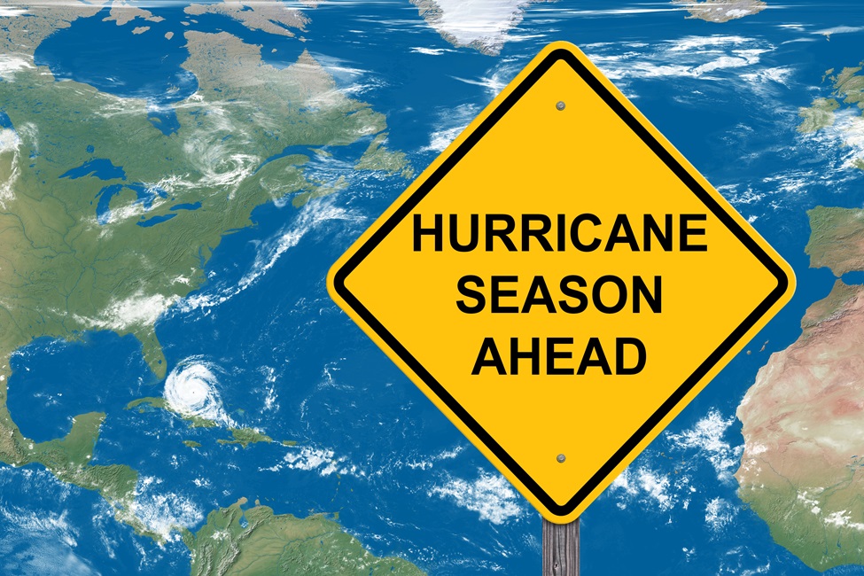 A caution sign for the hurricane season  with a satellite map background. 
