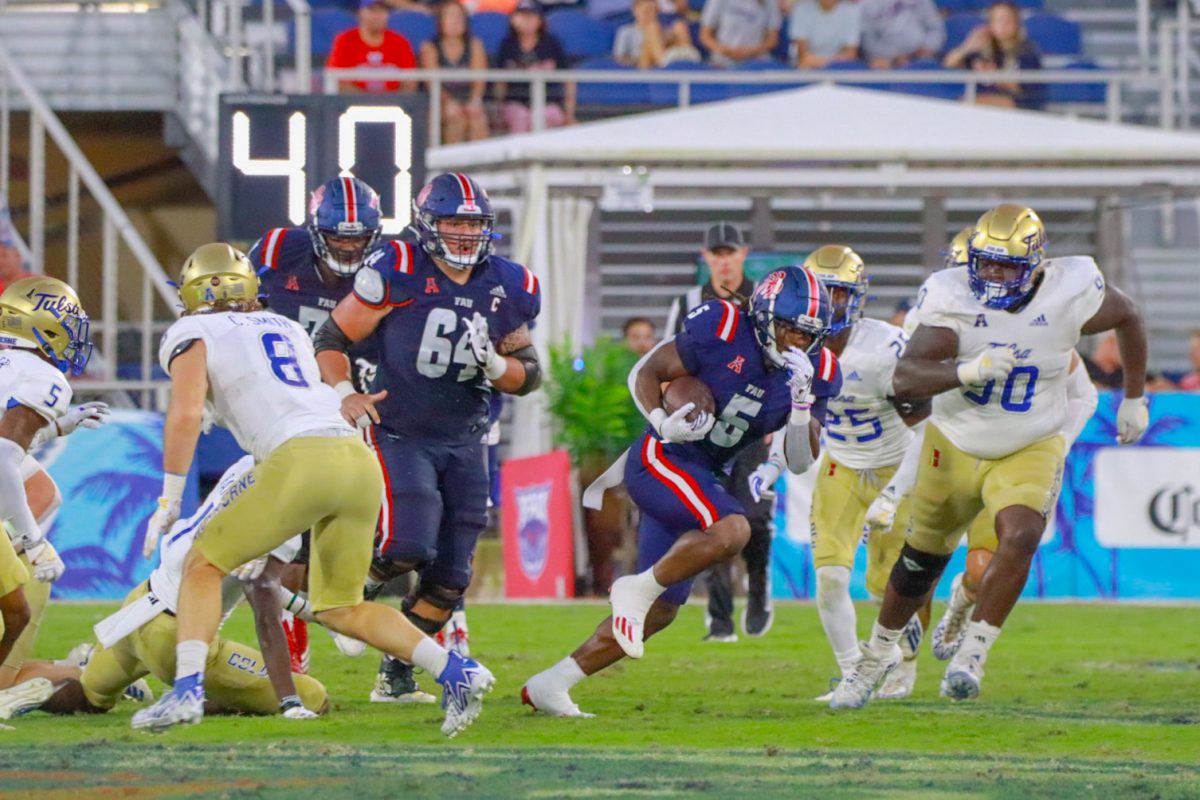 Graduate student and running back, Kobe Lewis, breaks through Tulsa’s defense for an FAU first down at Howard Schnellenberger Field in Boca Raton Fla, on Oct 7th 2023.
