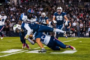 FAU linebacker Jackson Ambush bringing down a UConn player in the Owls 48-14 defeat on Sept. 21.