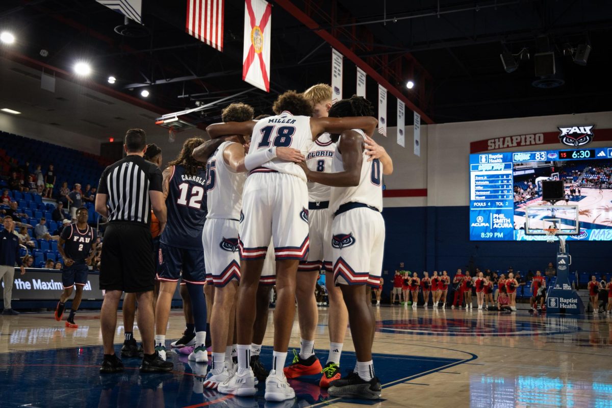 FAU’s men’s basketball team huddles up before a foul shot in a scrimmage at the Paradise Madness on Oct. 26, 2024