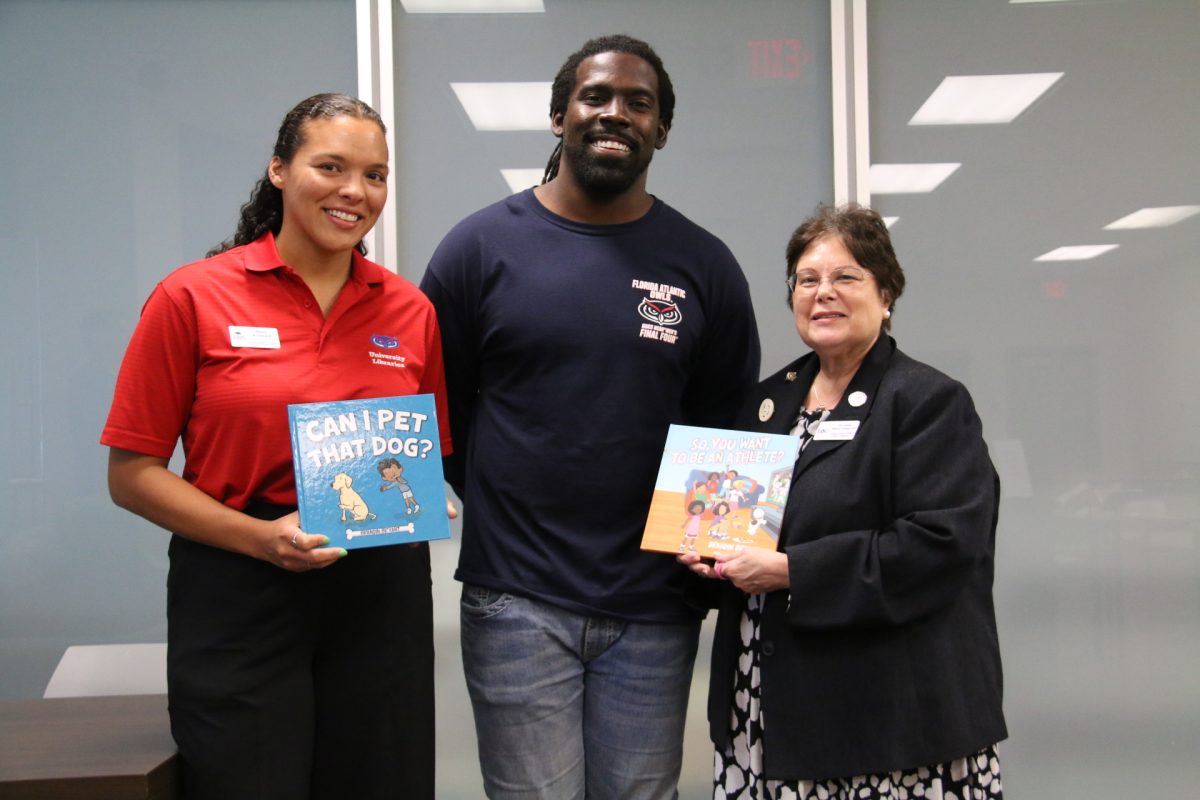 Bradin Bryant posing with his two children’s books with Linda Golian-Lui, PhD (right) and Alexis Broussard (left).