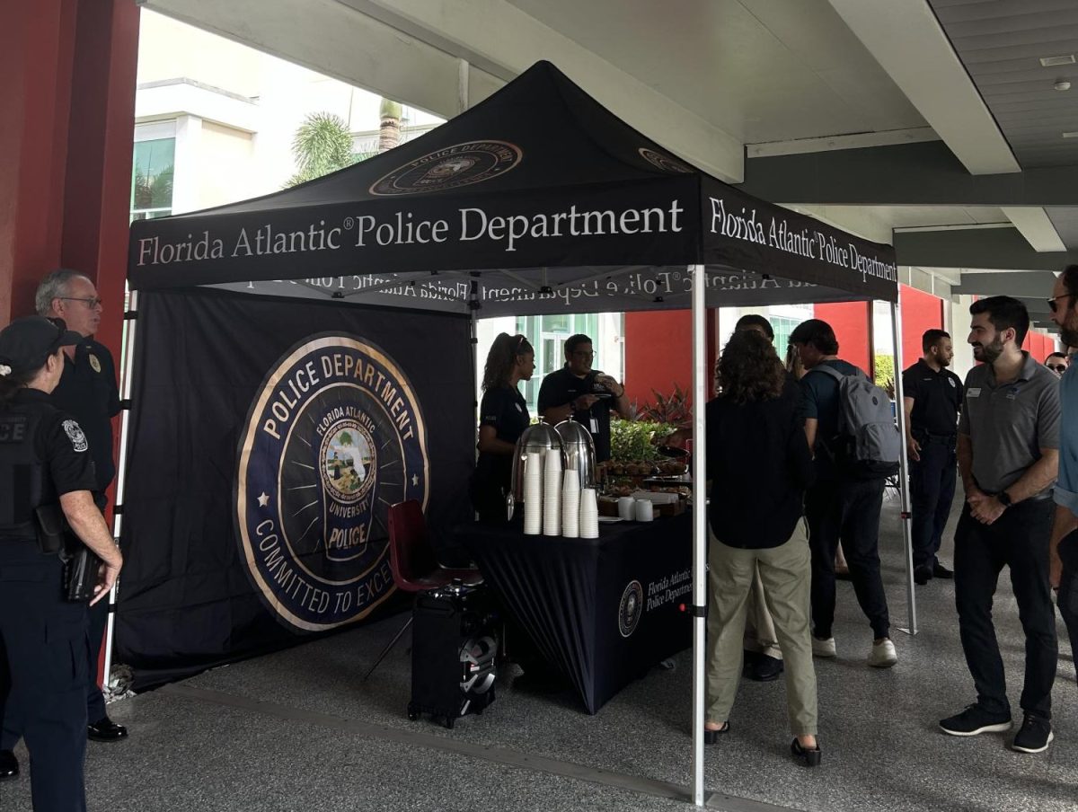 FAUPD hosts "Coffee with a Cop" with a tent set up on the breezeway. Students and faculty interact with FAU PD officers over coffee and pastries.  