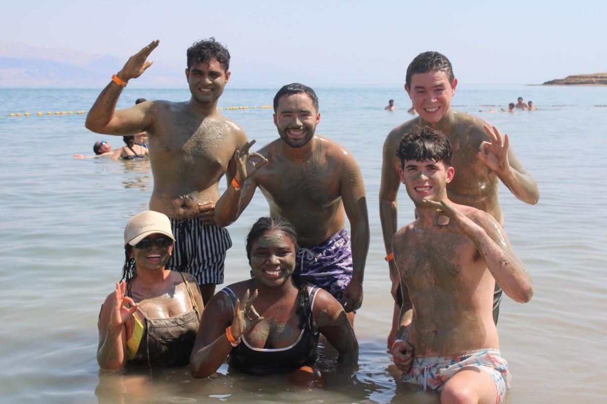 Yisset Hardy, Adam Latiff, Yoline Decosma, Alvaro Sopo, Tyler Scalley and Michael McCourt (left to right) covered in mud from the Dead Sea at Kalia Beach. 