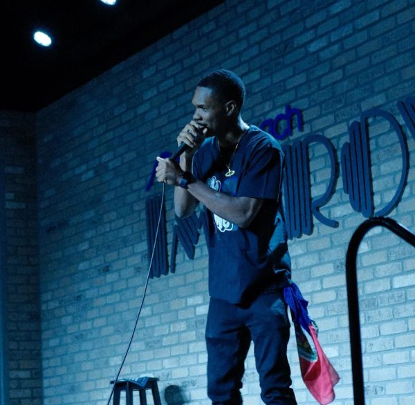 Slim performing at Dania Improv's comedy night in January 2023.