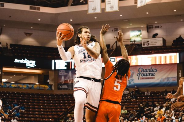 FAU forward Tre Carroll going for a layup against Oklahoma State's guard Khalil Brantley. 