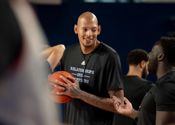 Assistant coach Isaiah Austin talking with special assistant to the head coach Obim Okeke at FAU's men's basketball practice. 