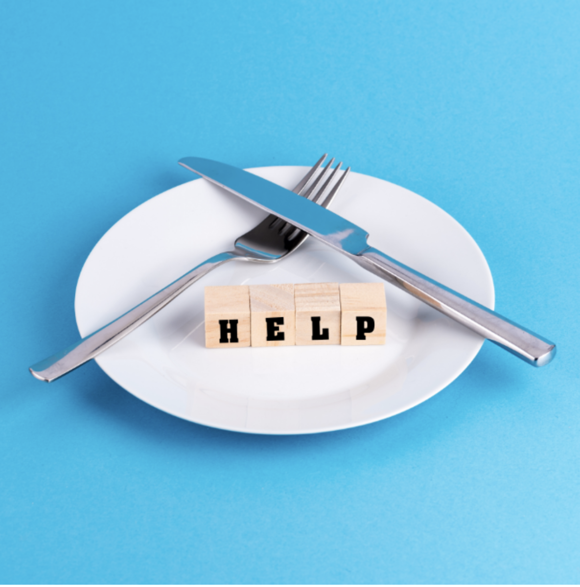 An image depicting an empty plate and a "help" sign. Eating disorders are psychological conditions that lead to unhealthy eating habits.