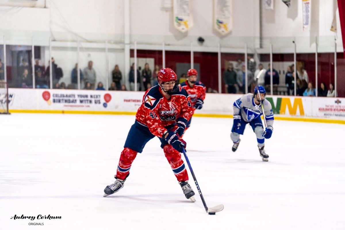 The Owls defenseman Justin Machovina with the puck in FAU's game against Lynn on Jan. 19, 2024. 