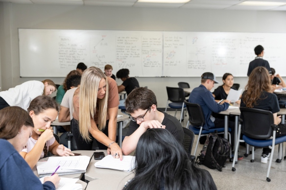 A learning assistant helping students in a precalculus and trigonometry class. (Photo courtesy of FAU's Quality Enhancement Plan website)