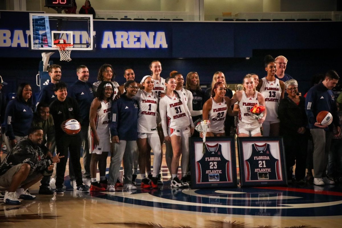 FAU's women's basketball team standing together to honor their two seniors during their game against Memphis. The Owls won 69-62 over the Tigers. 