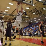 FAU center Dragan Sekelja hanging from the hoop. Photo by Melissa Landolfa.