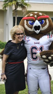 FAU president Mary Jane Saunders posing with the school's mascot, Owsley.