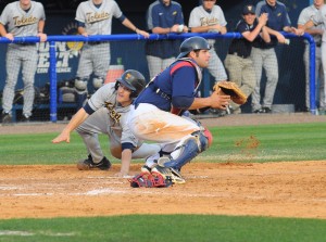 Catcher Mike Spano attempts to tag a runner out at home but was unsuccessful. Toledo won the Saturday game 6-1 over the Owls'. Photo by Michelle Friswell 