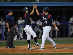 Third baseman Ricky Santiago (left) and left fielder Tyler Rocklein (right) celebrate after Rocklein's home run in the bottom of the seventh inning to propel the Owls' past Maine 15-6 Wednesday night. Photo by Michelle Friswell.