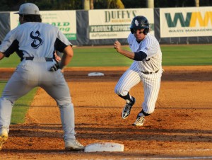 Center fielder Nathan Pittman survives a pickoff attempt at first base. Pittman collected one hit and one run during the Friday night win over FIU. Photo by Michelle Friswell.