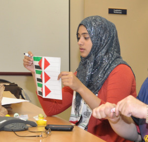 SJP member Nadine Aly makes decorations for their rescheduled event. Photo by Michelle Friswell.