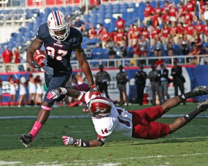 Running back Jonathan Wallace stiff-arming a Troy defender last season. Photo by Melissa Landolfa.