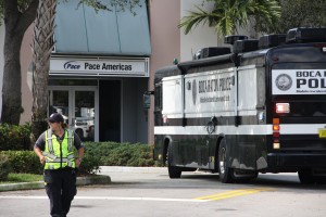  A member of FAU Parking and Transportation directs traffic on FAU Boulevard as Boca Raton Police investigate a shooting that occurred on the roof of the Pace Americas building in Innovation Centre Friday morning. Photo by Ryan Murphy.