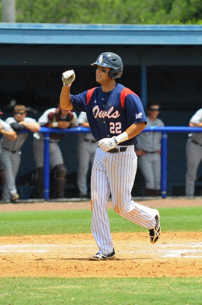 Third baseman Ricky Santiago scores his first of two runs in Saturday's noon game against the University of Arkansas-Little Rock. The Owls beat UARL 9-4 to start the doubleheader. Photo by Michelle Friswell