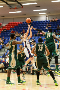 Pablo Bertone attempts a fadeaway jumper over the outstretched arm of a UAB defender. Photo by Max Jackson