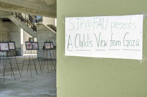 A poster informing students of the "A Child's View from Gaza" art display adorns the wall of the social sciences building.
